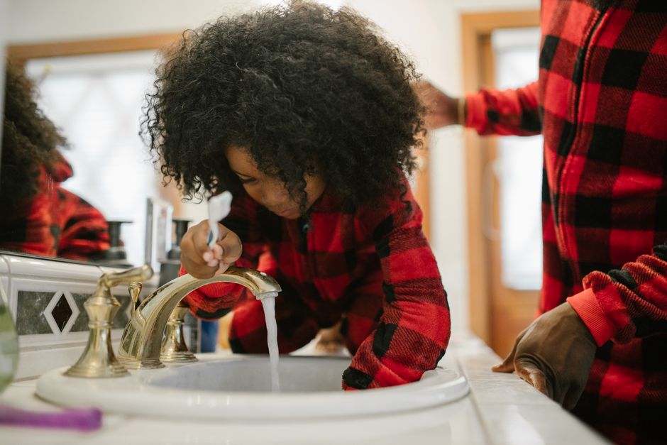 Child brushing teeth as part of an evening routine