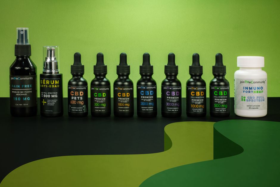 A variety of CBD jars and bottles on a vibrant green backdrop, Mexico City.