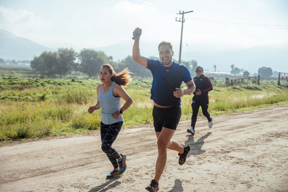 Group of people enjoying a morning run on a rural trail, embracing fitness and vitality.