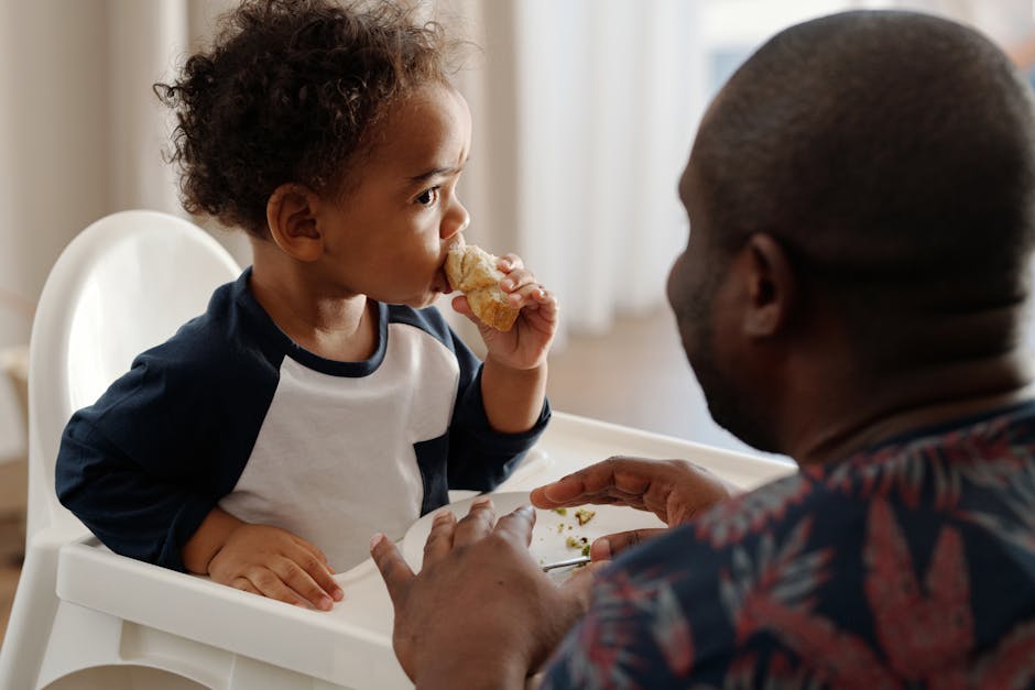 A father and his young son share a bonding moment during breakfast at home.
